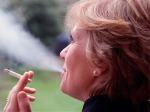 A196HJ Woman smoking a cigarette Exhaling tobacco smoke